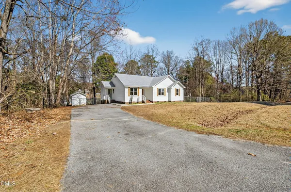 a view of white house with a yard