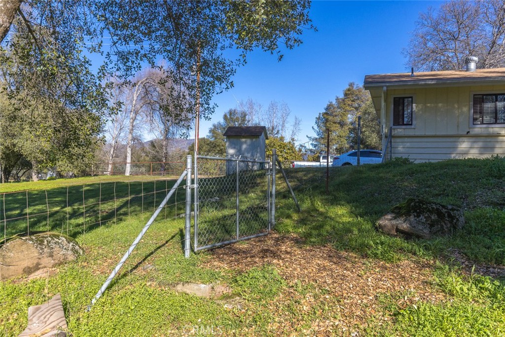 3977 Spring Court Mariposa, CA 95338 - Photo 27 of 72 a view of a house with a yard potted plants and a large tree