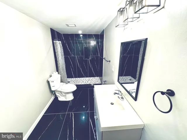 a bathroom with a toilet and a mirror