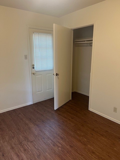 501 Hedgewood Drive, Unit C Georgetown, TX 78628 - Photo 14 of 17 a view of an empty room with wooden floor and closet