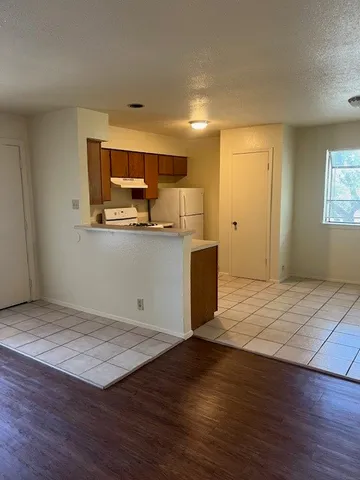 a white refrigerator freezer and a stove sitting inside of a kitchen