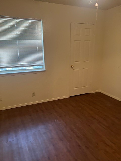 501 Hedgewood Drive, Unit C Georgetown, TX 78628 - Photo 10 of 17 an empty room with wooden floor and windows