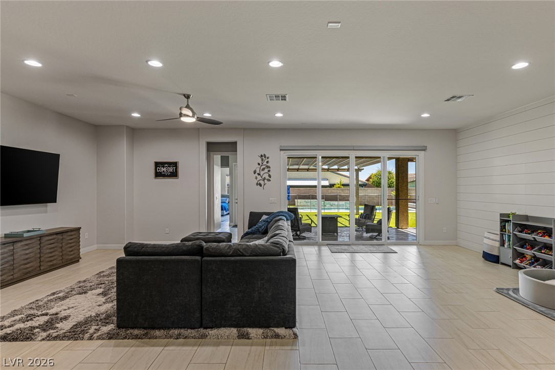 7036 Arabian Ridge Street Las Vegas, NV 89131 - Photo 19 of 64 Large great room area perfect for entertaining with large sliding glass door equipped with automated shades.