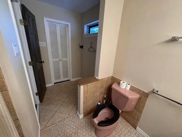 a view of walk in closet with wooden floor and stairs