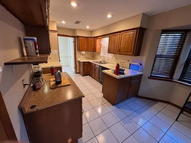 a kitchen with stainless steel appliances a refrigerator and microwave