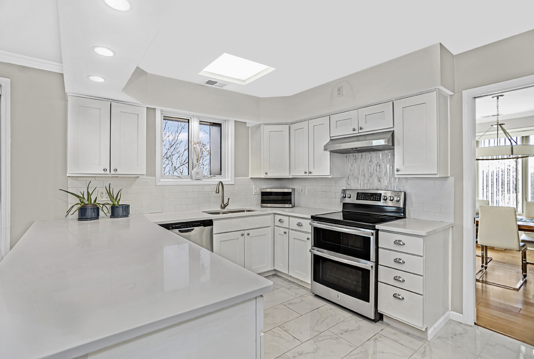 1125 Lake Cook Road, Unit 511 Northbrook, IL 60062 - Photo 7 of 18 a kitchen with stainless steel appliances a stove sink and cabinets