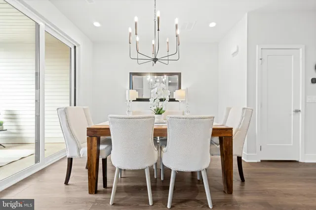 a view of a dining room with furniture wooden floor and a chandelier