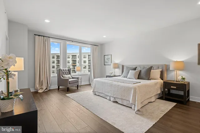 a spacious bedroom with a bed and a couch