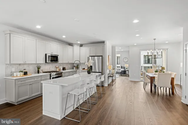 a kitchen with counter top space a sink appliances and cabinets