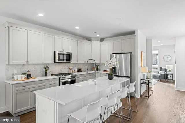 a kitchen with stainless steel appliances a refrigerator sink and cabinets