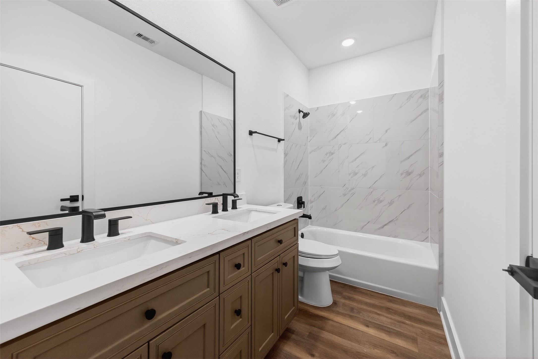 3003 A Delano Street Houston, TX 77004 - Photo 39 of 49 a bathroom with a double vanity sink toilet mirror and bathtub
