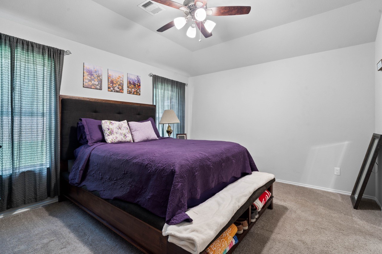 9931 Spring Creek Road Cleveland, TX 77327 - Photo 5 of 38 Spacious primary bedroom with walk in closet located on the opposite side of house from other 2 rooms.