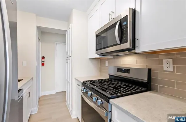 a kitchen with a stove and a microwave