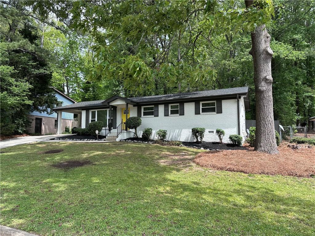 4396 Greenleaf Circle Southwest Atlanta, GA 30331 - Photo 1 of 18 a front view of a house with a garden