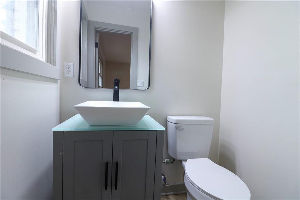 4396 Greenleaf Circle Southwest Atlanta, GA 30331 - Photo 16 of 18 a bathroom with a sink toilet and mirror