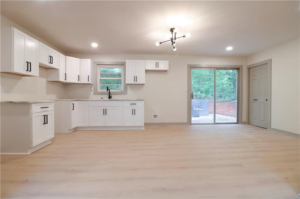 4396 Greenleaf Circle Southwest Atlanta, GA 30331 - Photo 4 of 18 a large white kitchen with window and cabinets