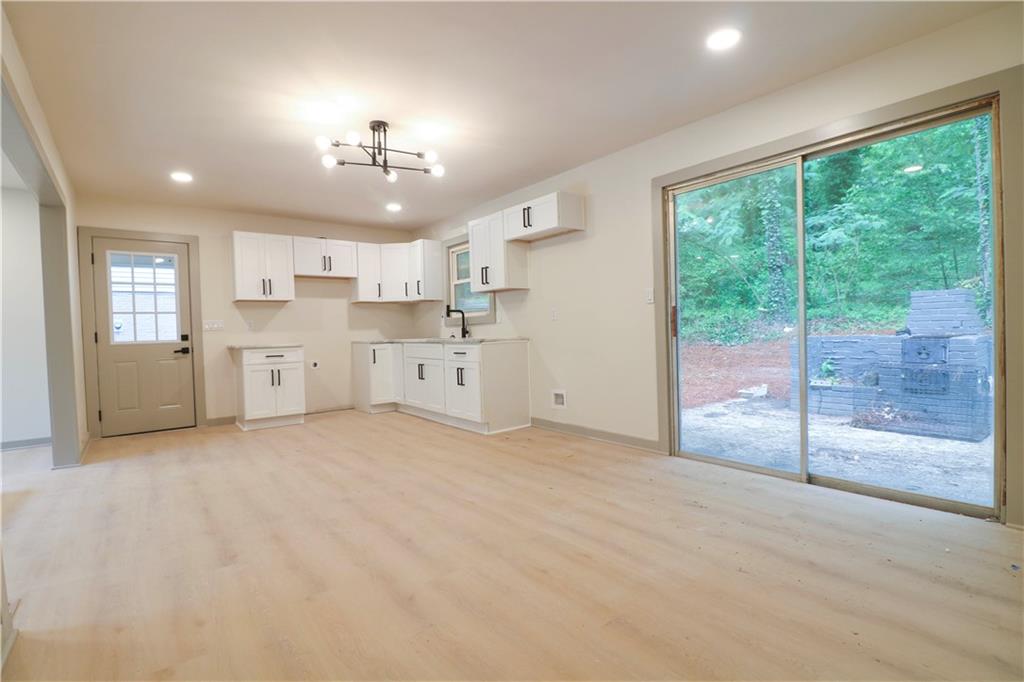 4396 Greenleaf Circle Southwest Atlanta, GA 30331 - Photo 7 of 18 a large kitchen with a large window and stainless steel appliances
