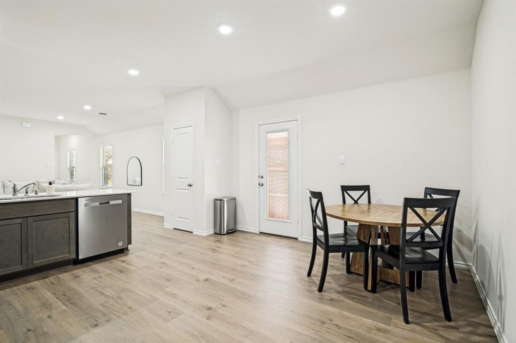 609 Nature Stroll Road Lavon, TX 75166 - Photo 5 of 13 Open-concept living space with wood-finish flooring, recessed lighting, white walls, and a glass-paneled rear exit door