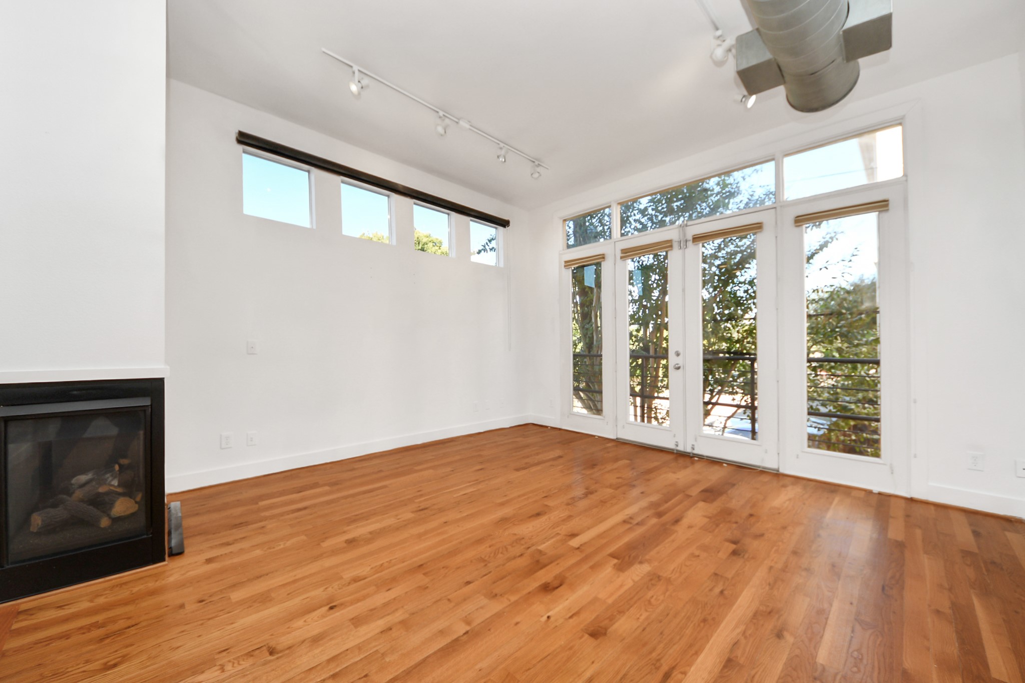 2436 Bissonnet Street, Unit 8 Houston, TX 77005 - Photo 12 of 42 a view of an empty room with wooden floor and a window
