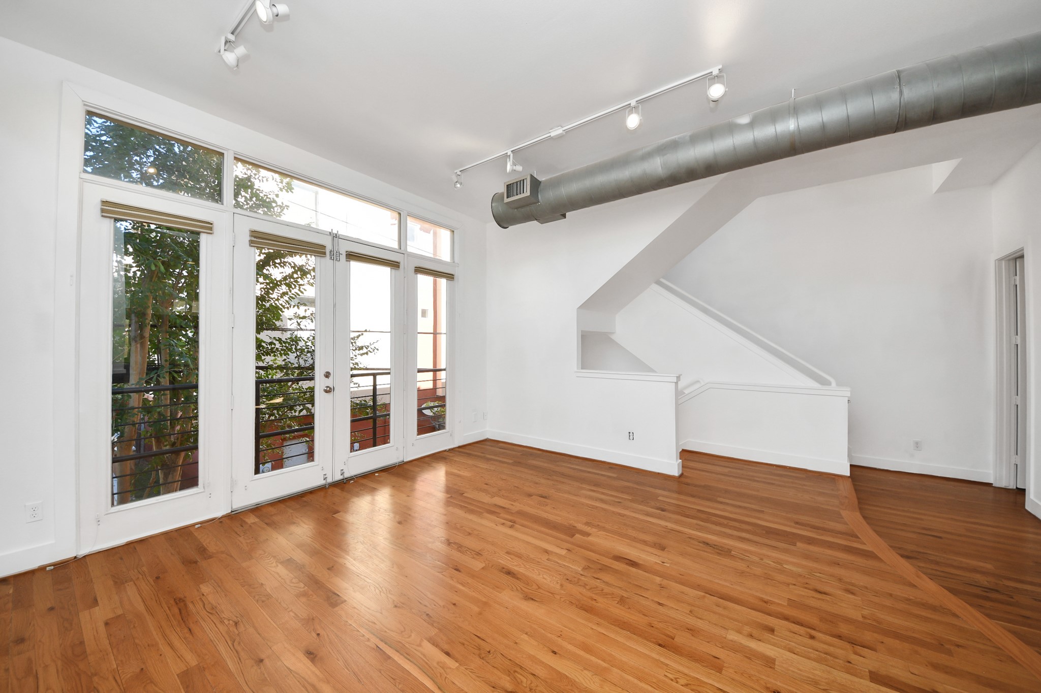 2436 Bissonnet Street, Unit 8 Houston, TX 77005 - Photo 15 of 42 wooden floor in an empty room with a window