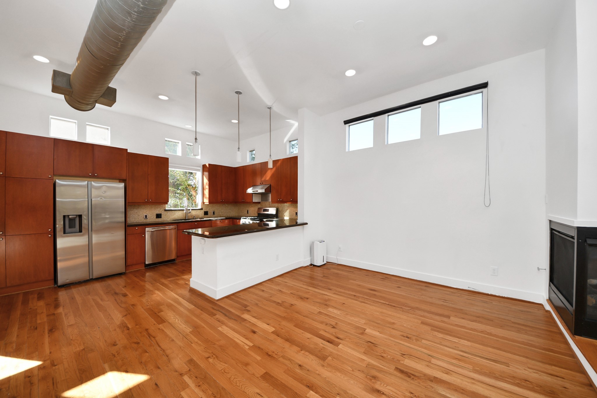 2436 Bissonnet Street, Unit 8 Houston, TX 77005 - Photo 16 of 42 a kitchen with stainless steel appliances kitchen island granite countertop a refrigerator a sink and a stove