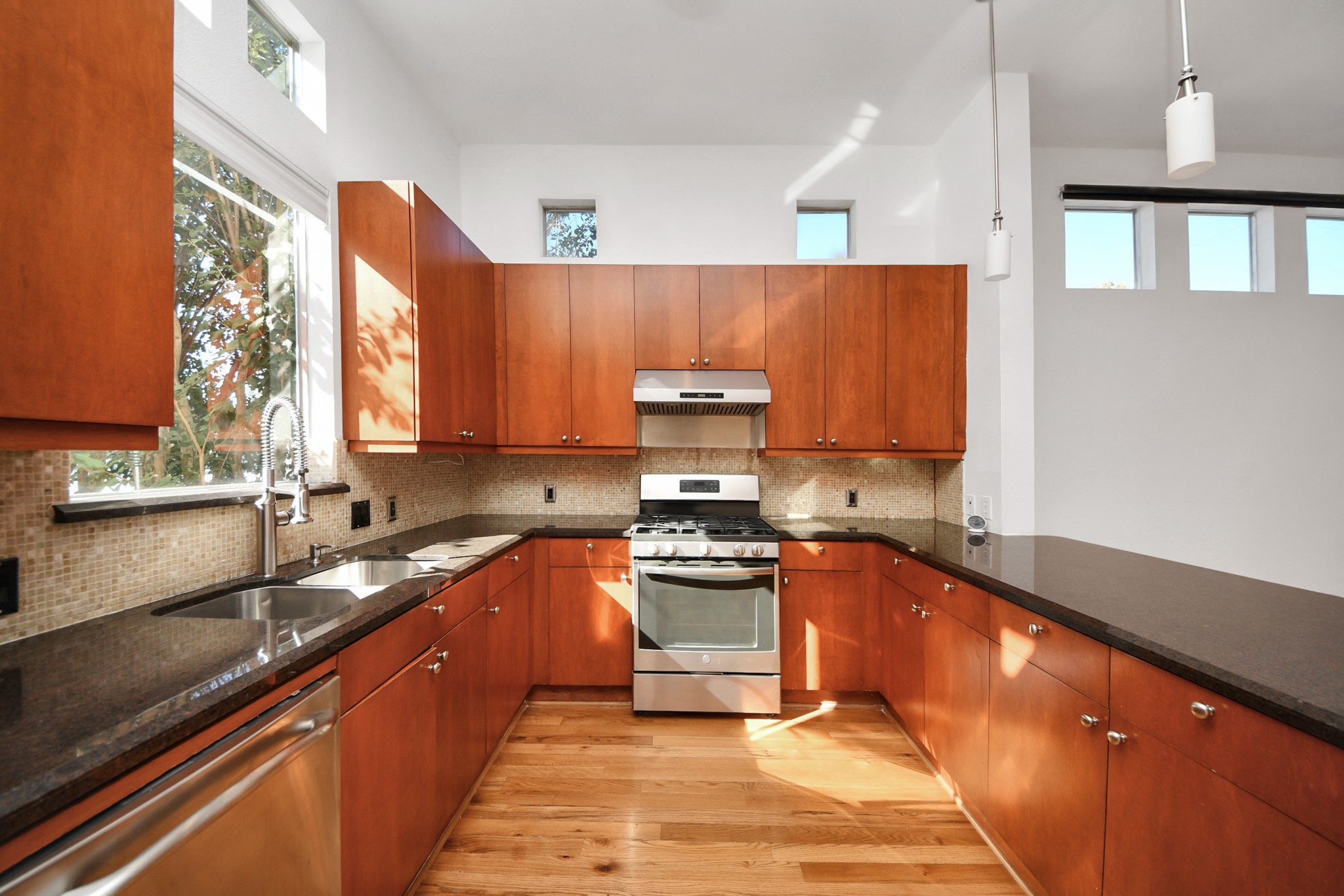 2436 Bissonnet Street, Unit 8 Houston, TX 77005 - Photo 22 of 42 a kitchen with stainless steel appliances granite countertop a sink stove and microwave