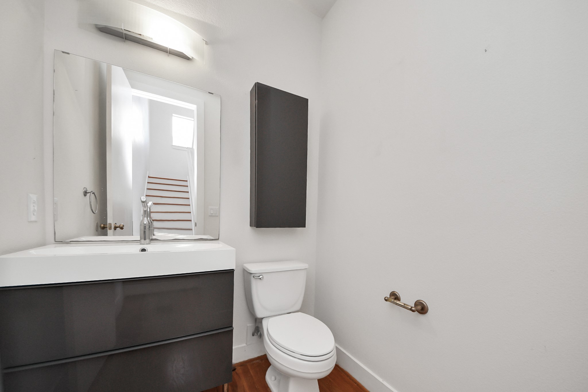 2436 Bissonnet Street, Unit 8 Houston, TX 77005 - Photo 26 of 42 a bathroom with a toilet a sink and mirror