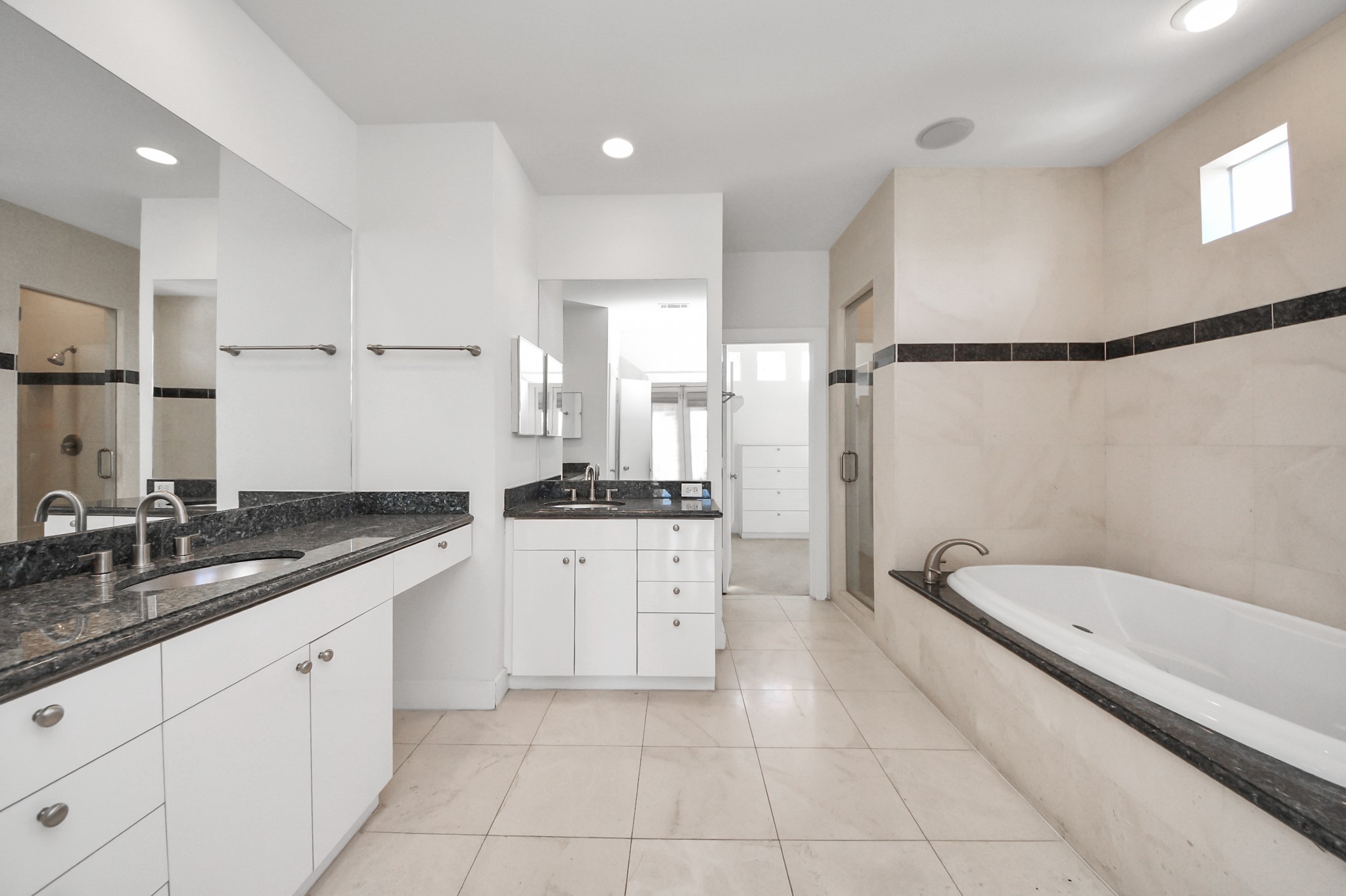 2436 Bissonnet Street, Unit 8 Houston, TX 77005 - Photo 29 of 42 a spacious bathroom with a granite countertop sink a mirror and a bathtub
