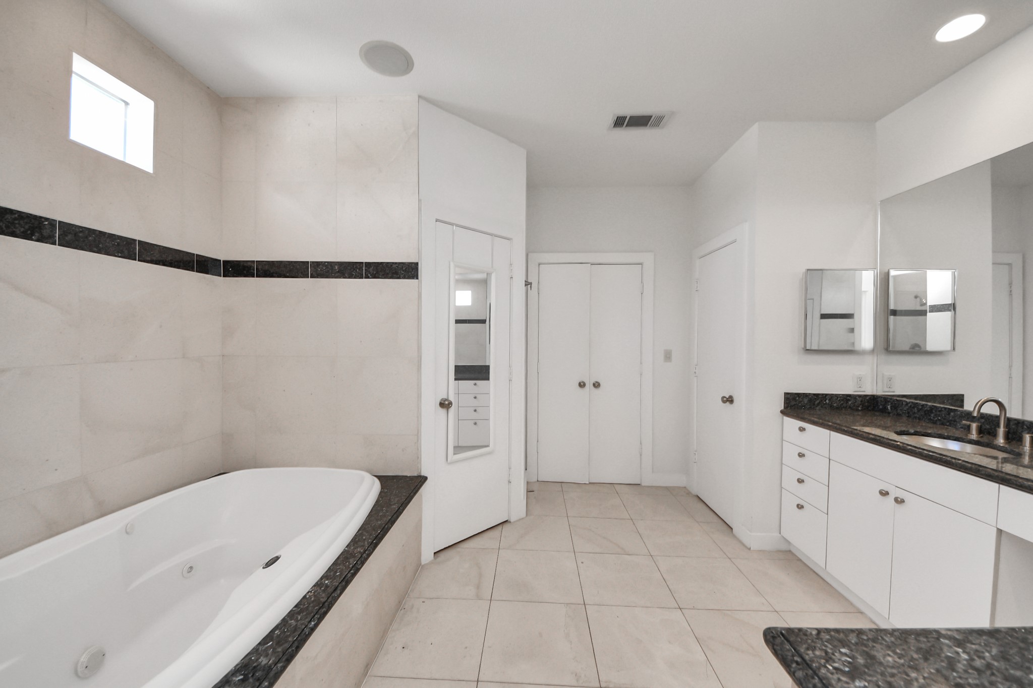 2436 Bissonnet Street, Unit 8 Houston, TX 77005 - Photo 32 of 42 a spacious bathroom with a granite countertop sink a mirror and a bathtub