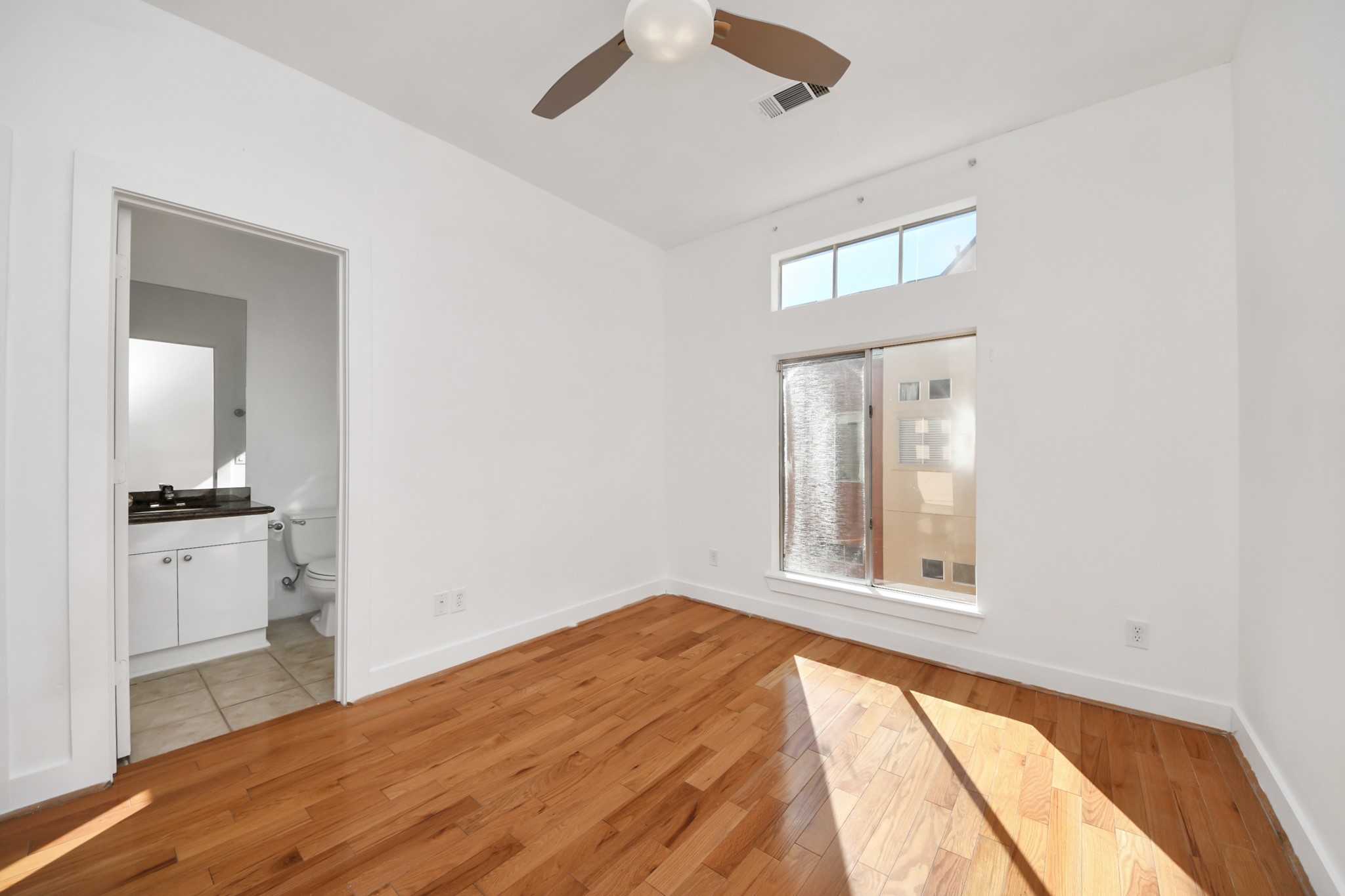 2436 Bissonnet Street, Unit 8 Houston, TX 77005 - Photo 36 of 42 an empty room with a bathroom and a window