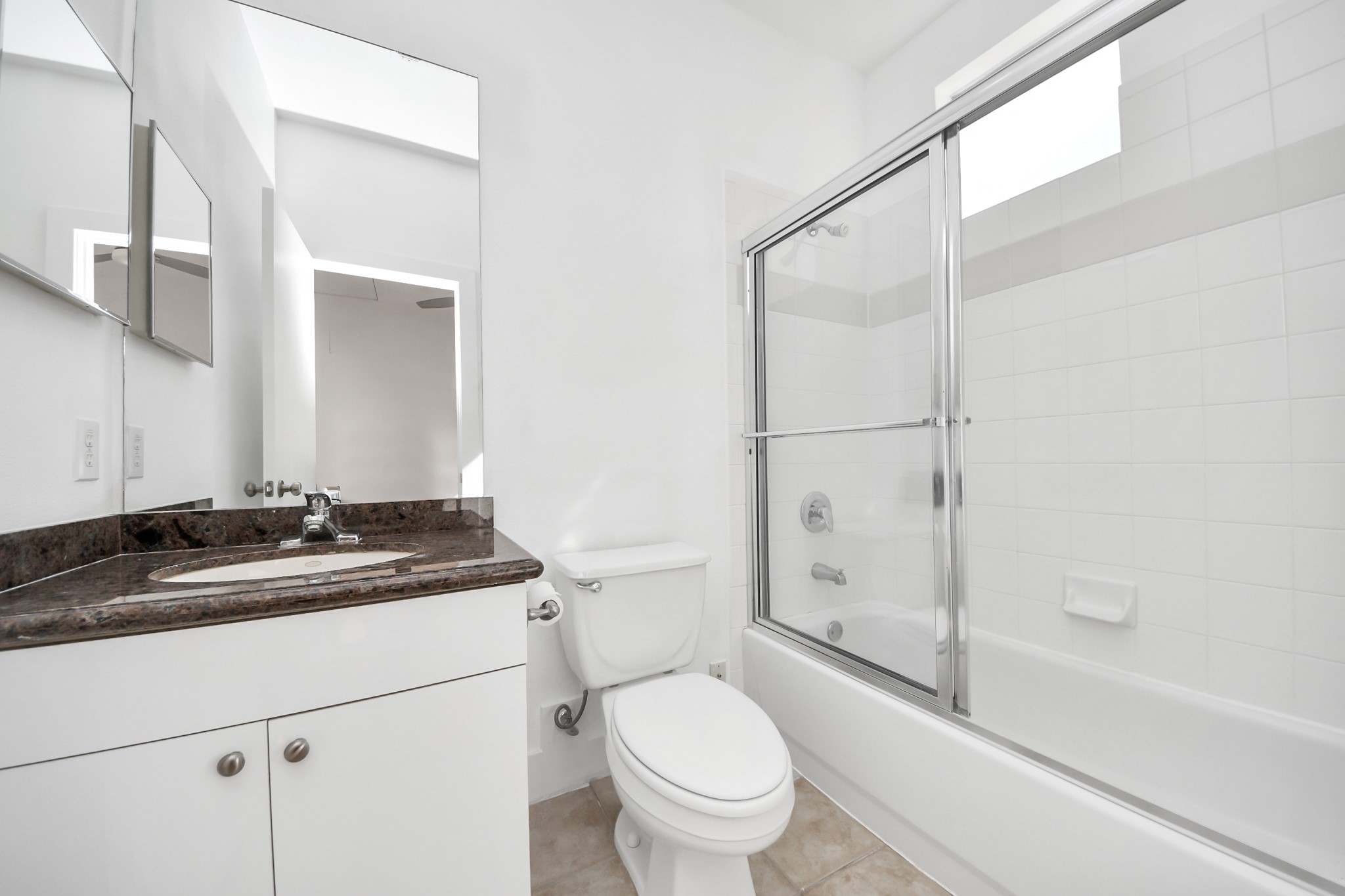 2436 Bissonnet Street, Unit 8 Houston, TX 77005 - Photo 38 of 42 a bathroom with a granite countertop sink toilet and shower