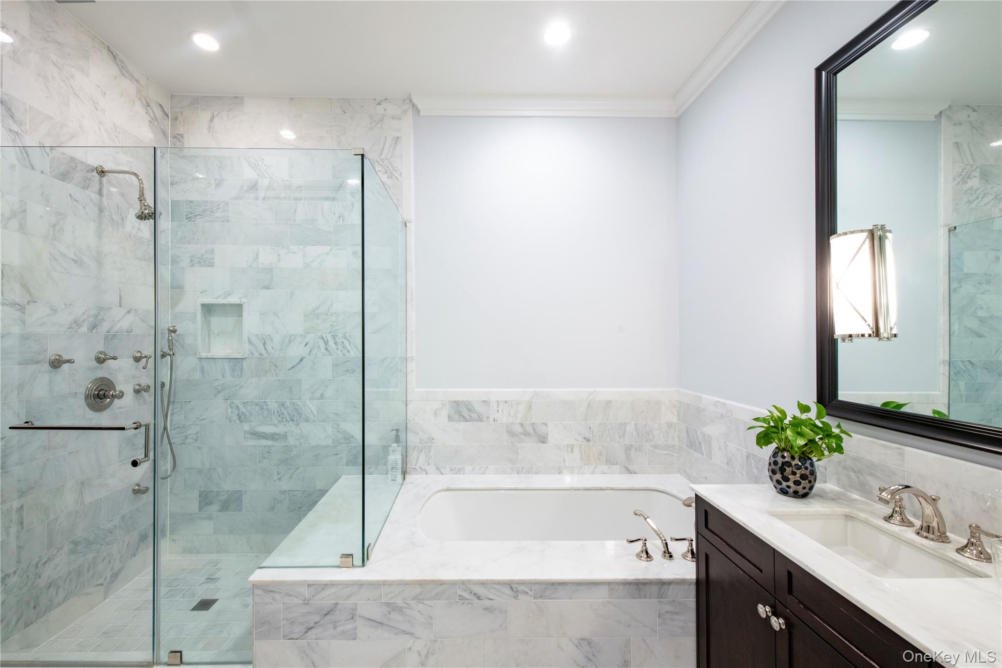 1000 Royal Court, Unit 1306 North Hills, NY 11040 - Photo 10 of 33 a bathroom with a bathtub shower sink and mirror