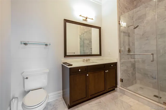 a bathroom with a toilet a sink and shower