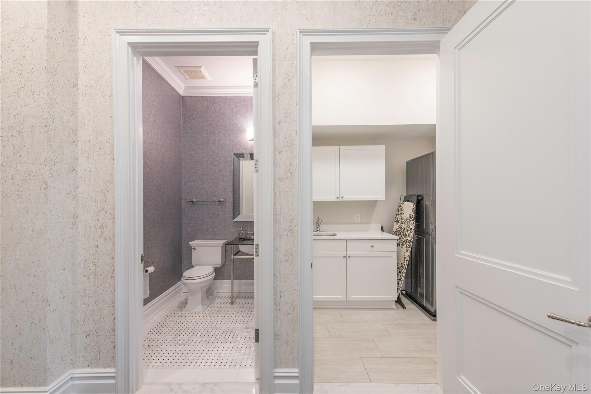 1000 Royal Court, Unit 1306 North Hills, NY 11040 - Photo 18 of 33 a bathroom with a granite countertop sink mirror and a toilet