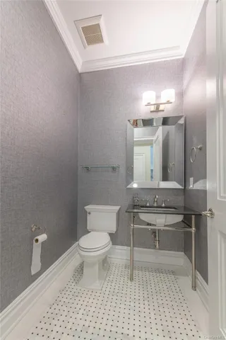 a bathroom with a sink a toilet and a mirror