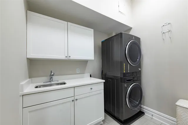 a utility room with sink dryer and washer