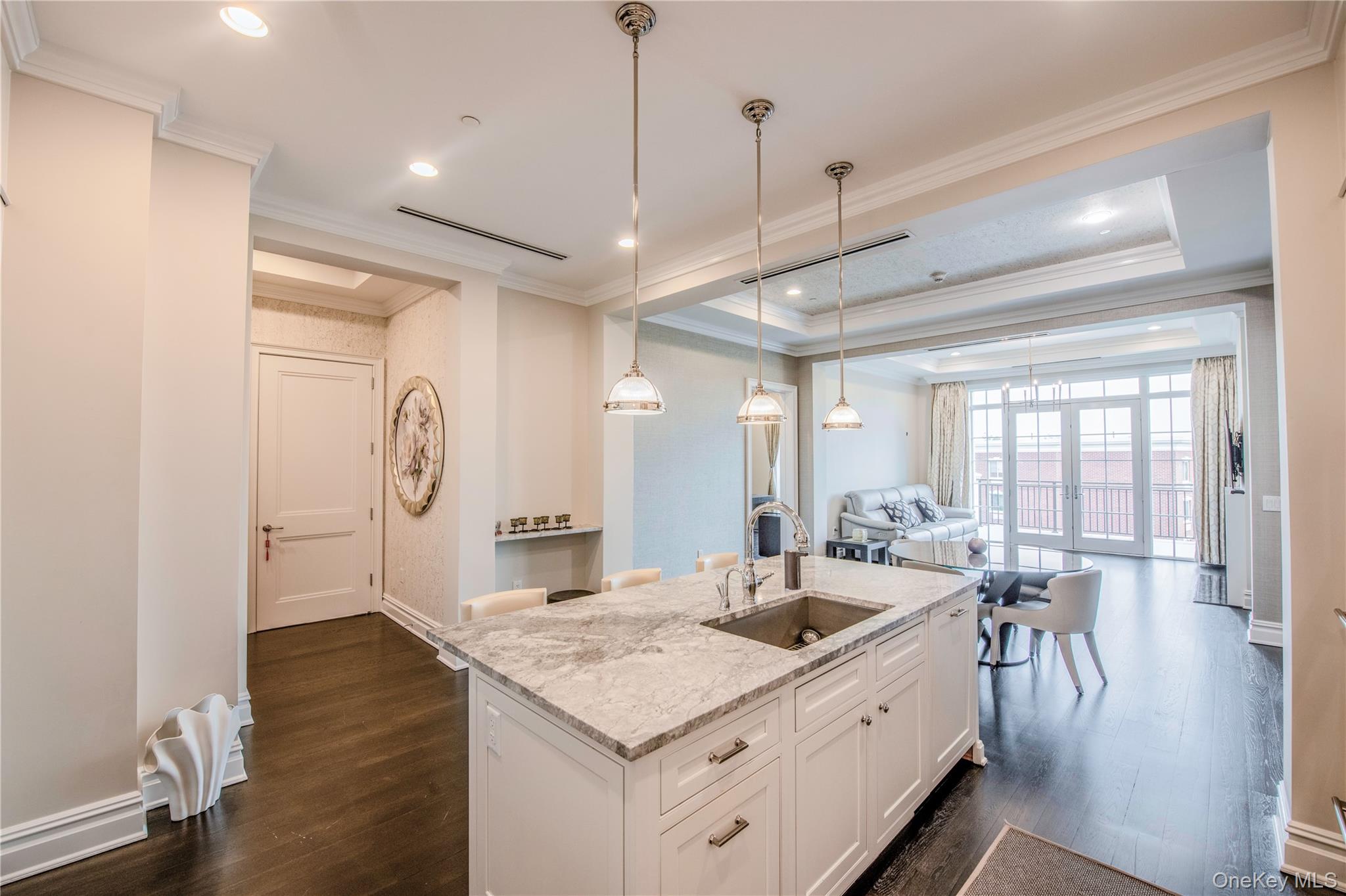 1000 Royal Court, Unit 1306 North Hills, NY 11040 - Photo 33 of 33 a large kitchen with kitchen island a large island in it