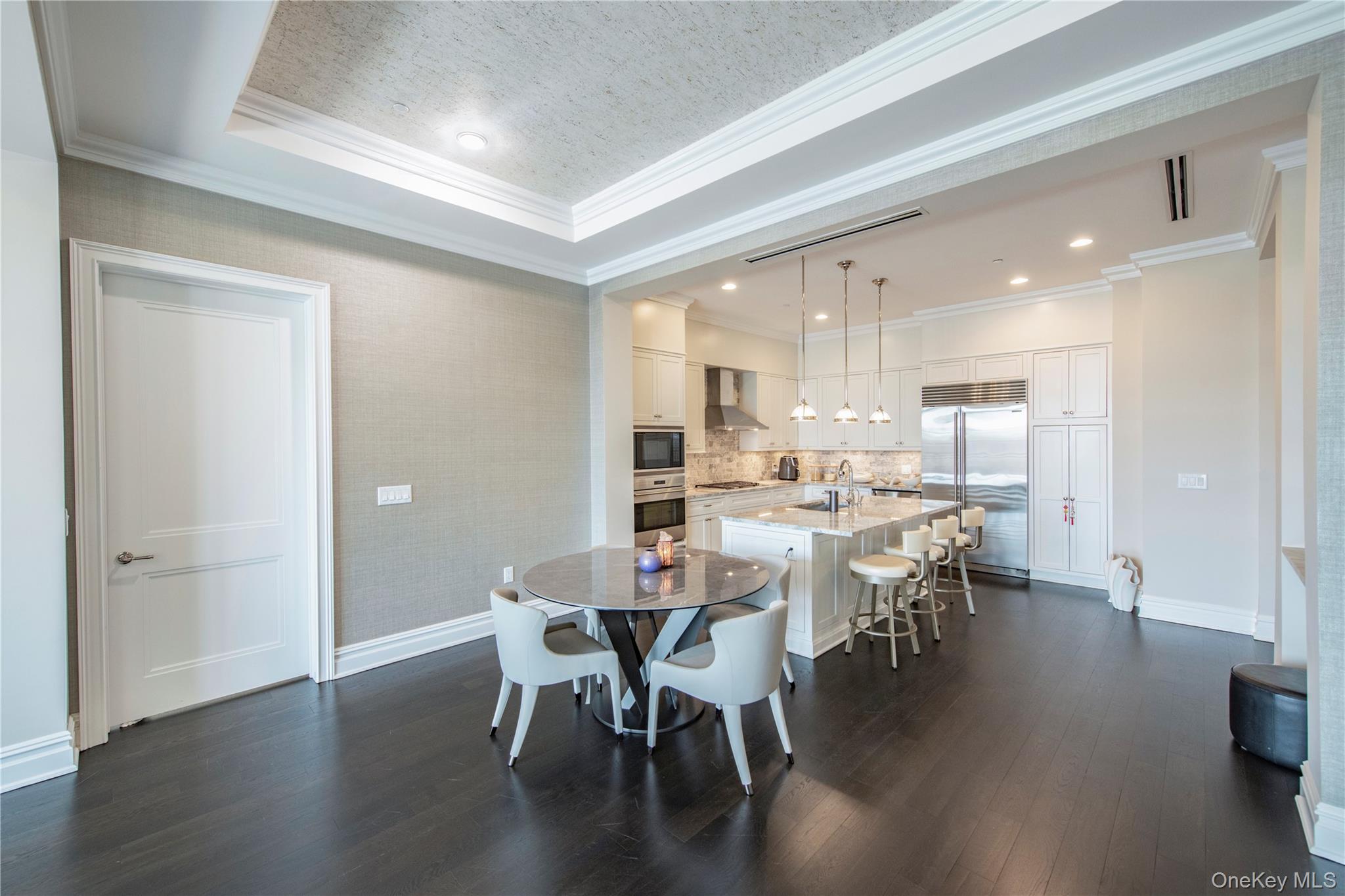 1000 Royal Court, Unit 1306 North Hills, NY 11040 - Photo 4 of 33 a view of a dining room with furniture and wooden floor