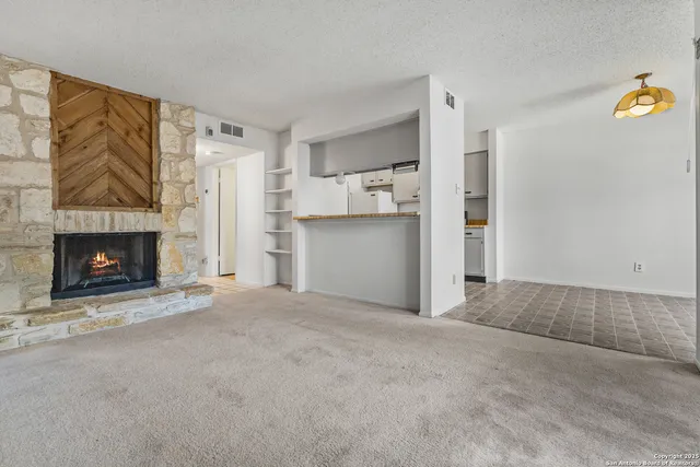 a view of a kitchen with a refrigerator and a sink