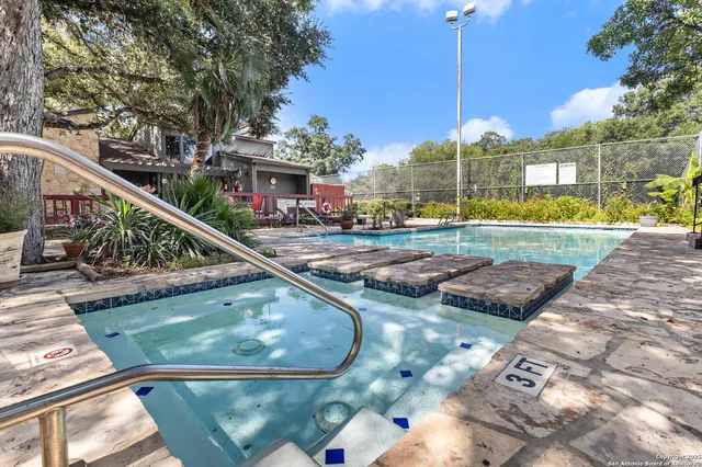 a roof deck with table and chairs