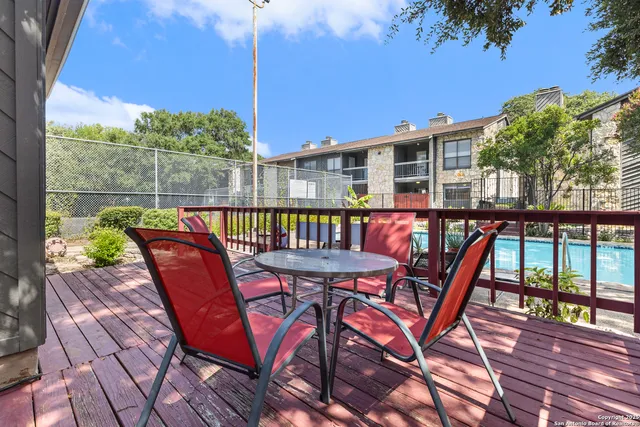 a backyard of a house with table and chairs