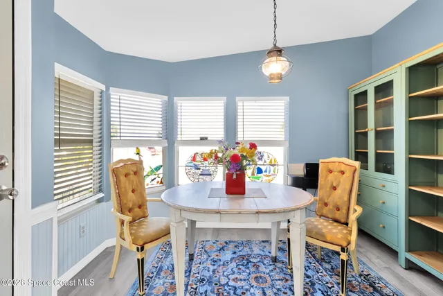 a dining room with furniture and window