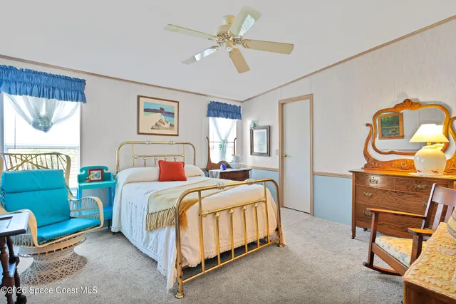 a bed room with a bed and a chair