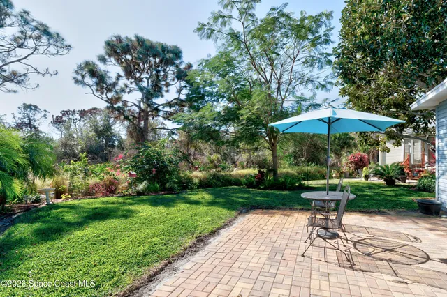 a view of a table and chairs under an umbrella