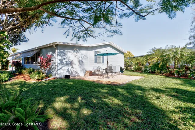 a view of a chairs and table in a yard