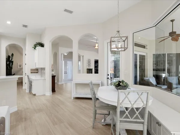 a view of a dining room with furniture and wooden floor