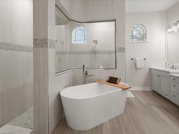 a bathroom with a bathtub and shower