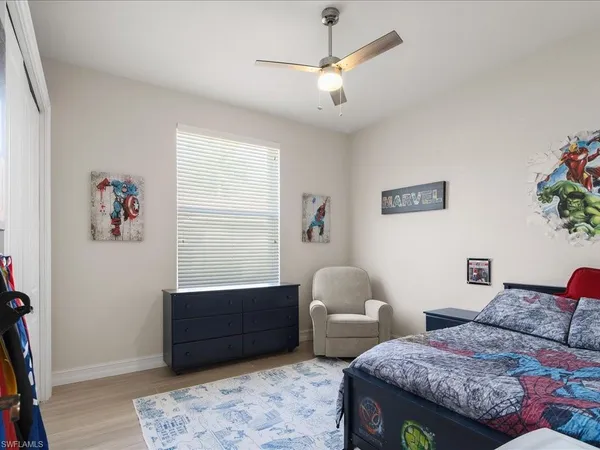 a bedroom with furniture and a potted plant