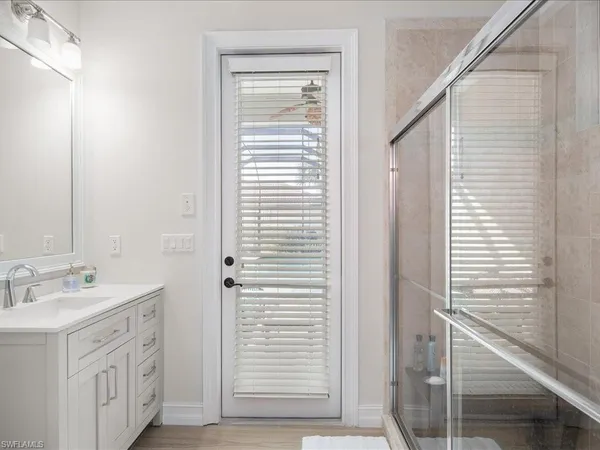 a bathroom with a sink a mirror and shower