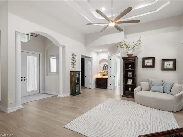 a living room with furniture and a chandelier